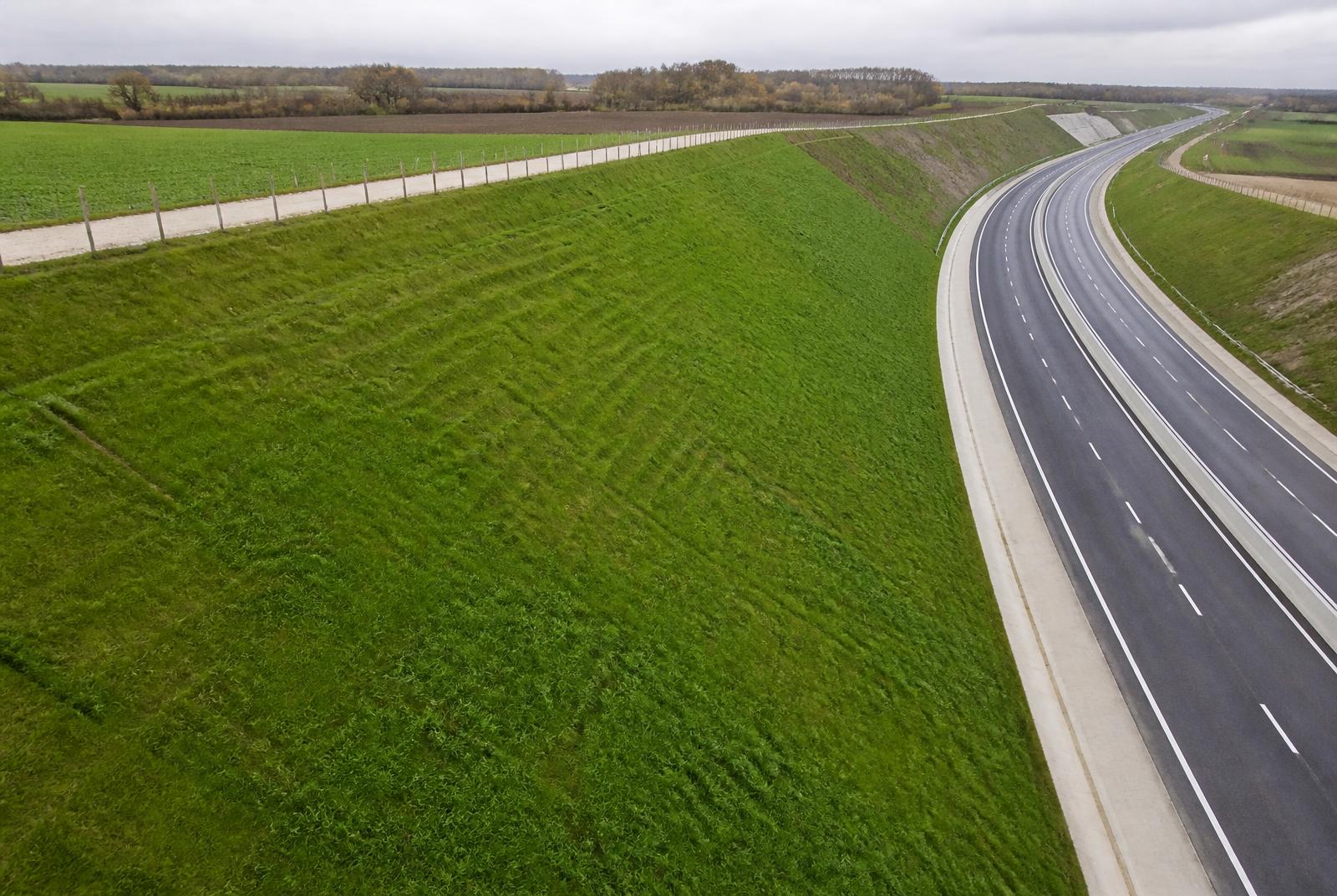 Remblai routier entièrement revégétalisé avec un couvert herbacé dense et homogène